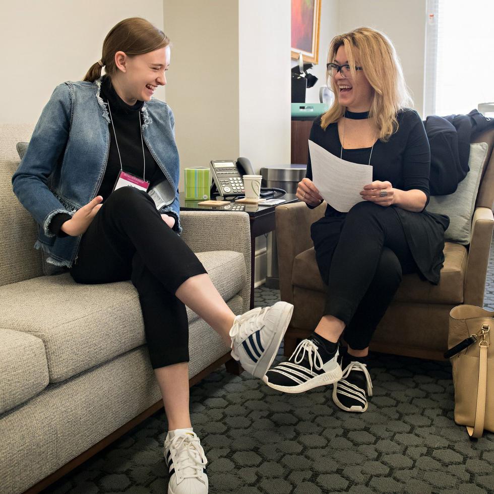 An alumna speaking with a student 